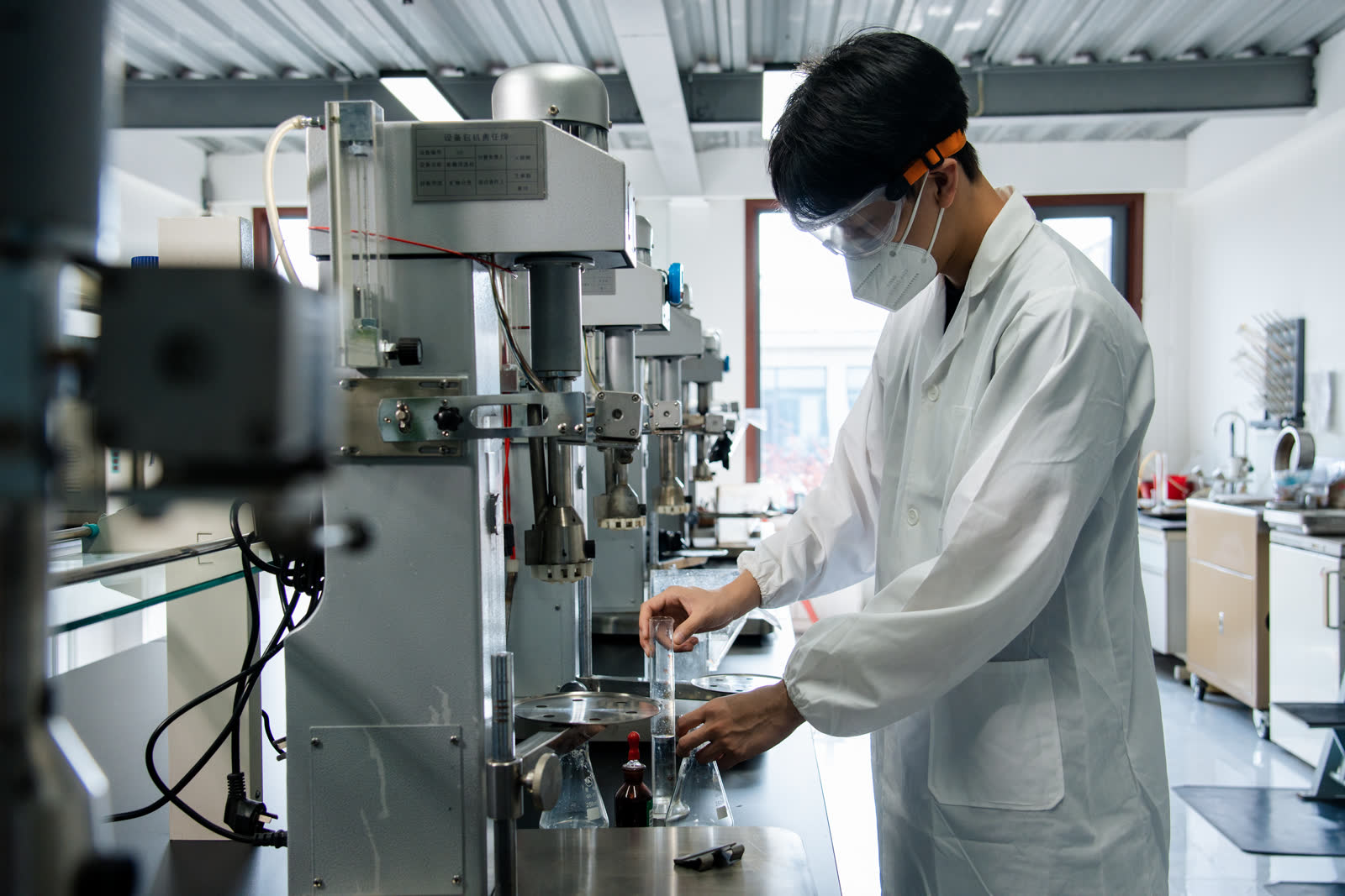 QINGQUAN laboratory technician operating a flotation testing machine